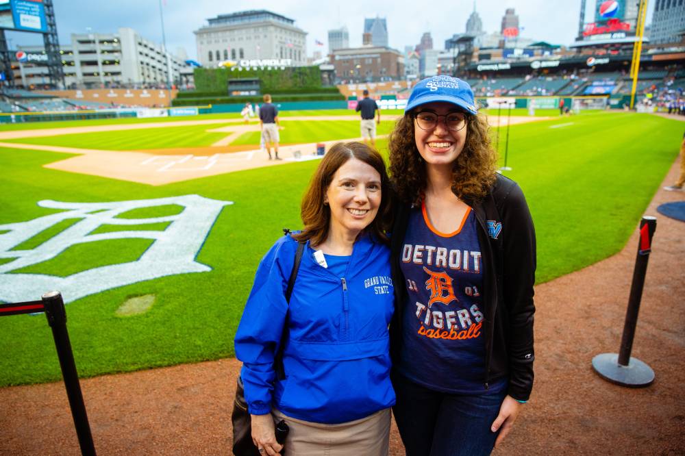 A mother and daughter pose together on the infield of comerica park